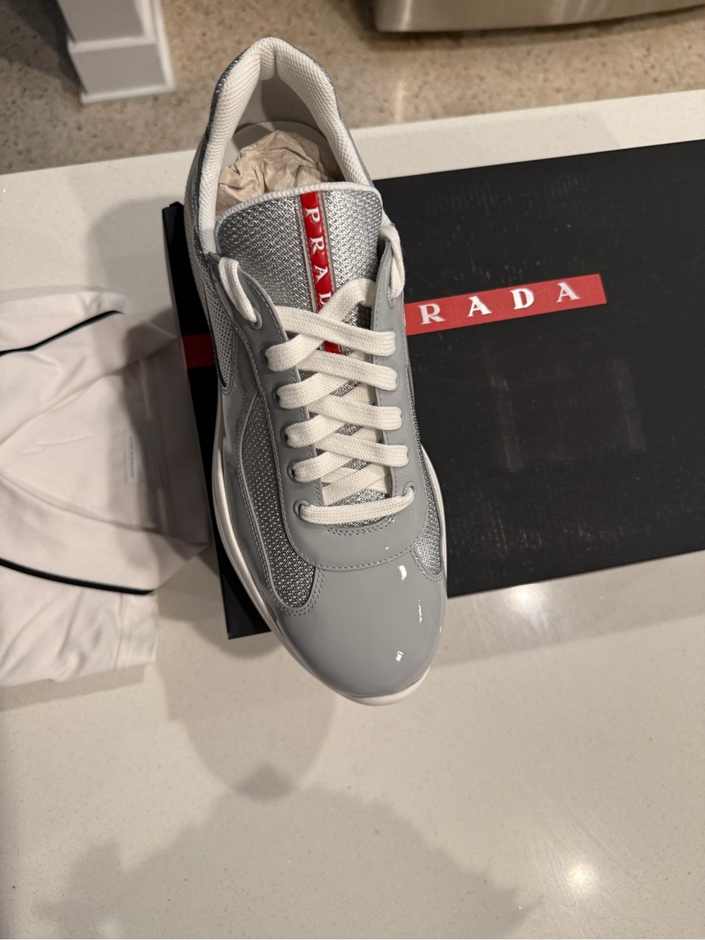 Prada Men’s Light Gray and White Lace-Up Sneakers with Red Logo Tape